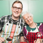 Younger male cook with older woman