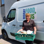 Moray Food Plus van and woman deliverer with tray of goods