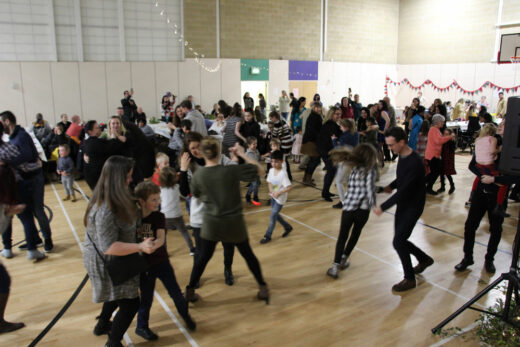 People dancing at a busy ceilidh